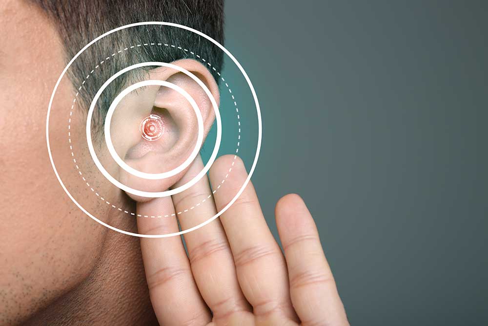 A close-up of a person’s ear with one hand cupped behind it, overlaid with concentric circles, symbolizing listening, hearing, or auditory issues.